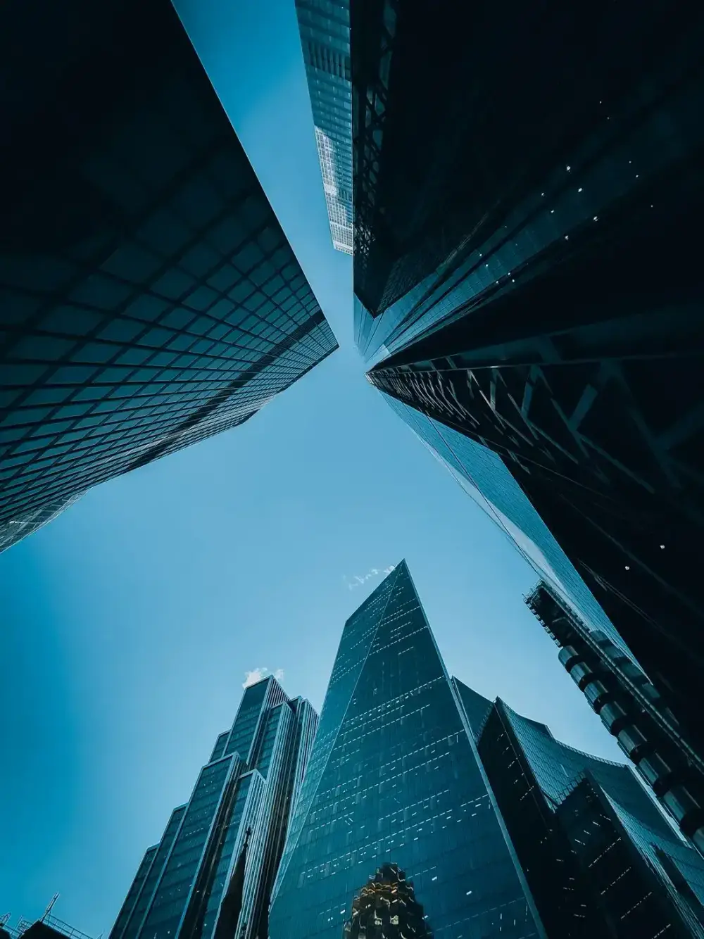 Looking up at glass towers in a financial district